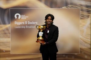Man proudly holds trophy at Gold Industry Group Diggers & Dealers Leadership Breakfast award ceremony.