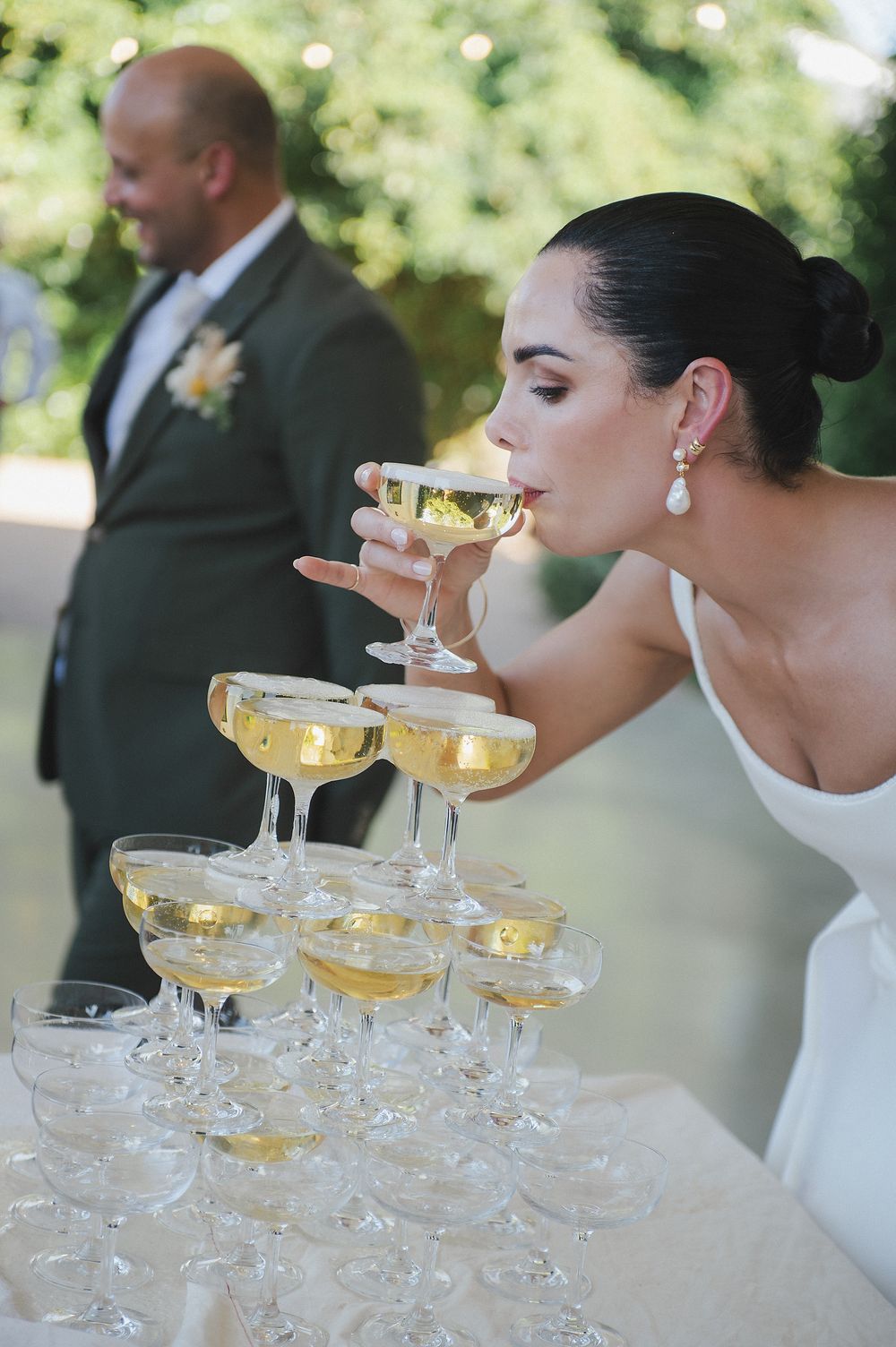 Bride Lizre having a sip of the champagne tower