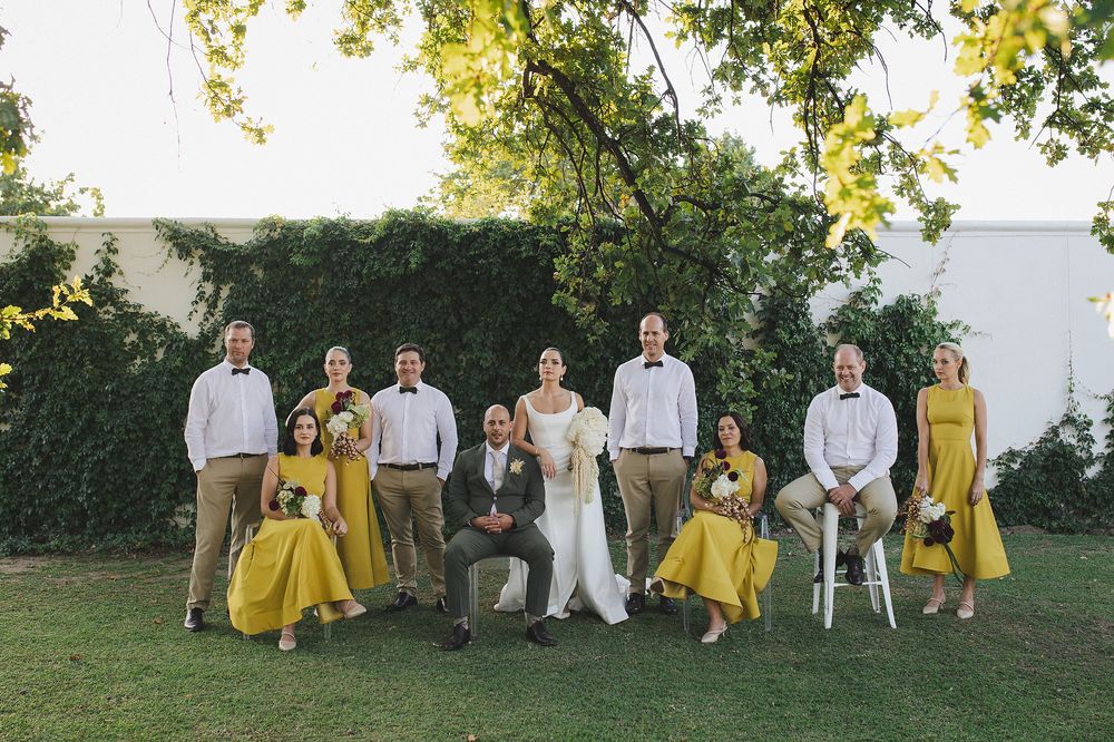 Bridal and groom parties posing for an editorial photo with bride and groom.