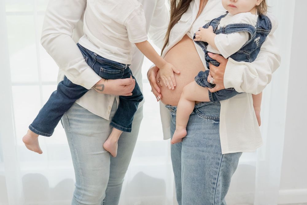 Maternity Family Photo Session by Conroe Photographer and Houston Photographer, Studio, white top and blue jeans