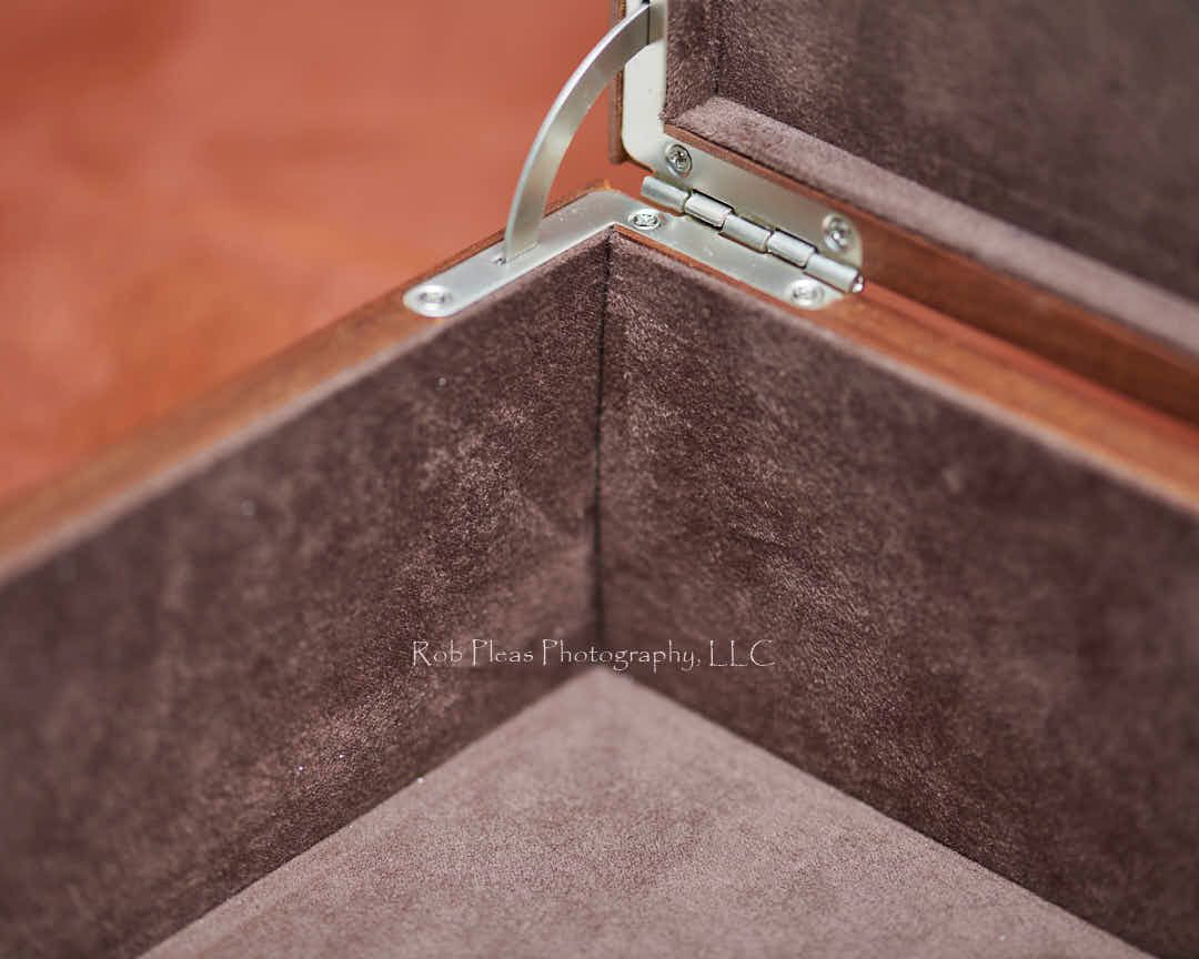 Closeup of interior of premium walnut folio box from Rob Pleas Photography, LLC.  Shows soft-closing hinges and fuzzy interior.
