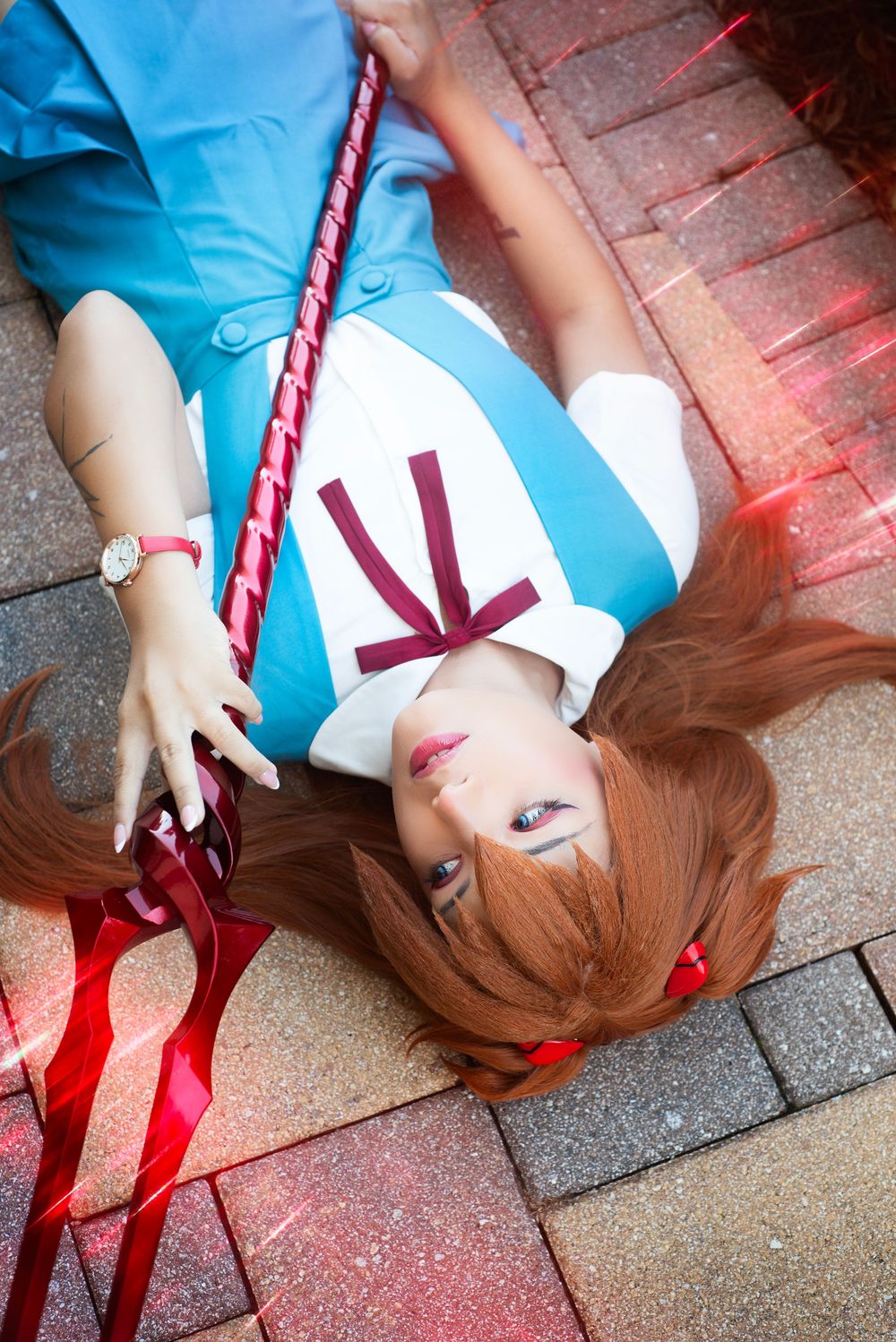 Cosplay character at Holiday Matsuri portrait interacting with camera, dynamic pose with staff prop