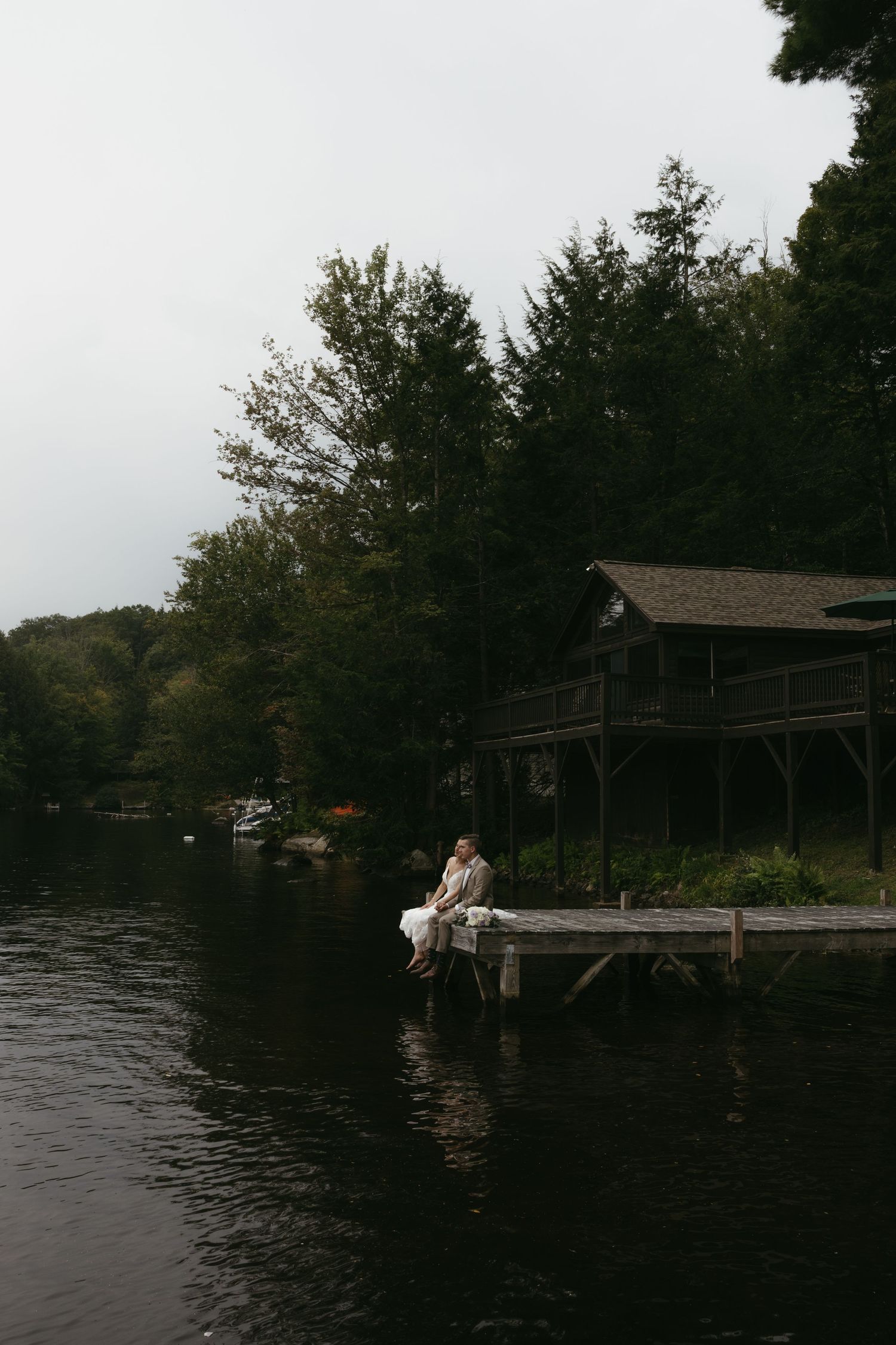 Bride and Groom sitting on dock at New Hampshire Wedding