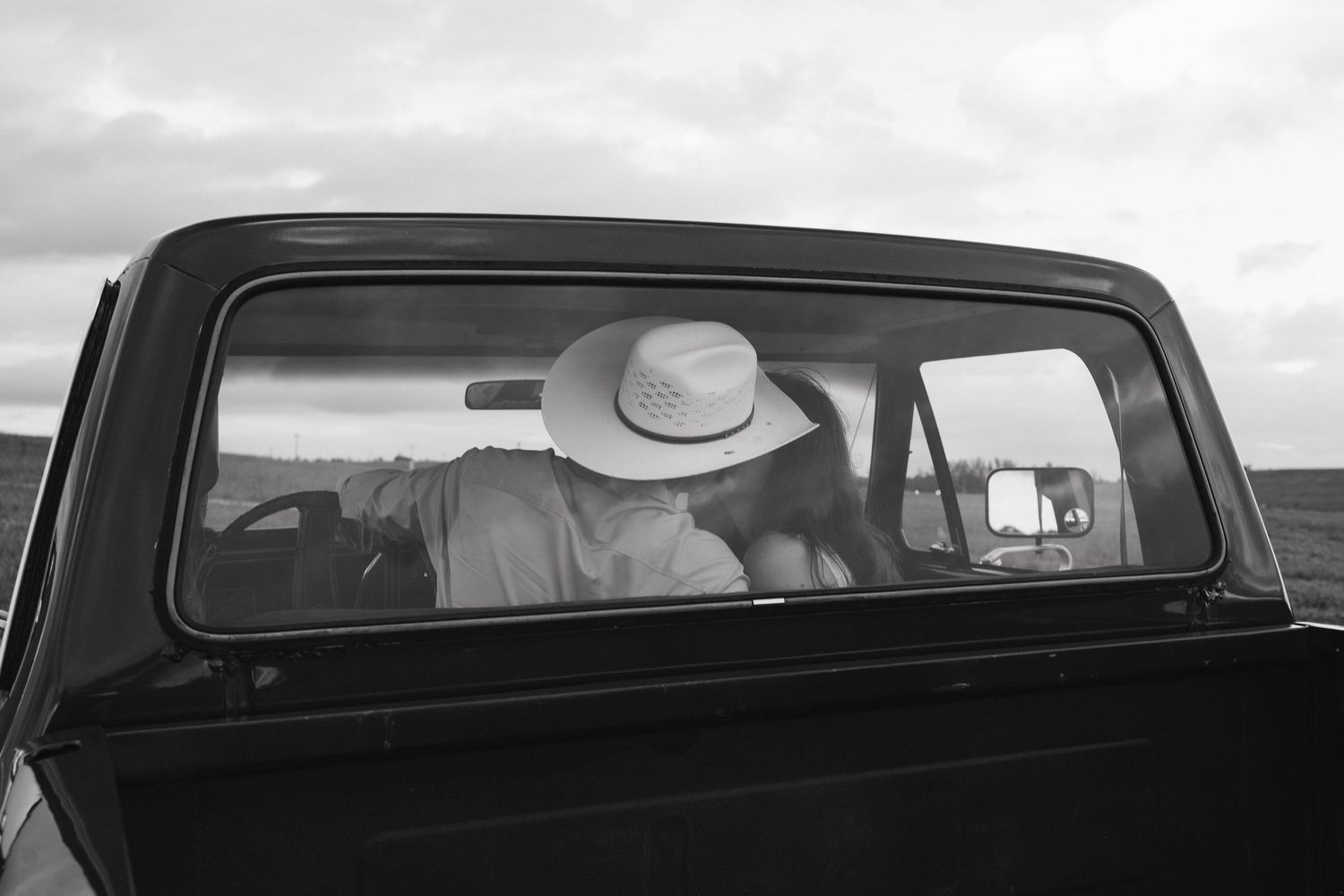 Couple kissing through truck window