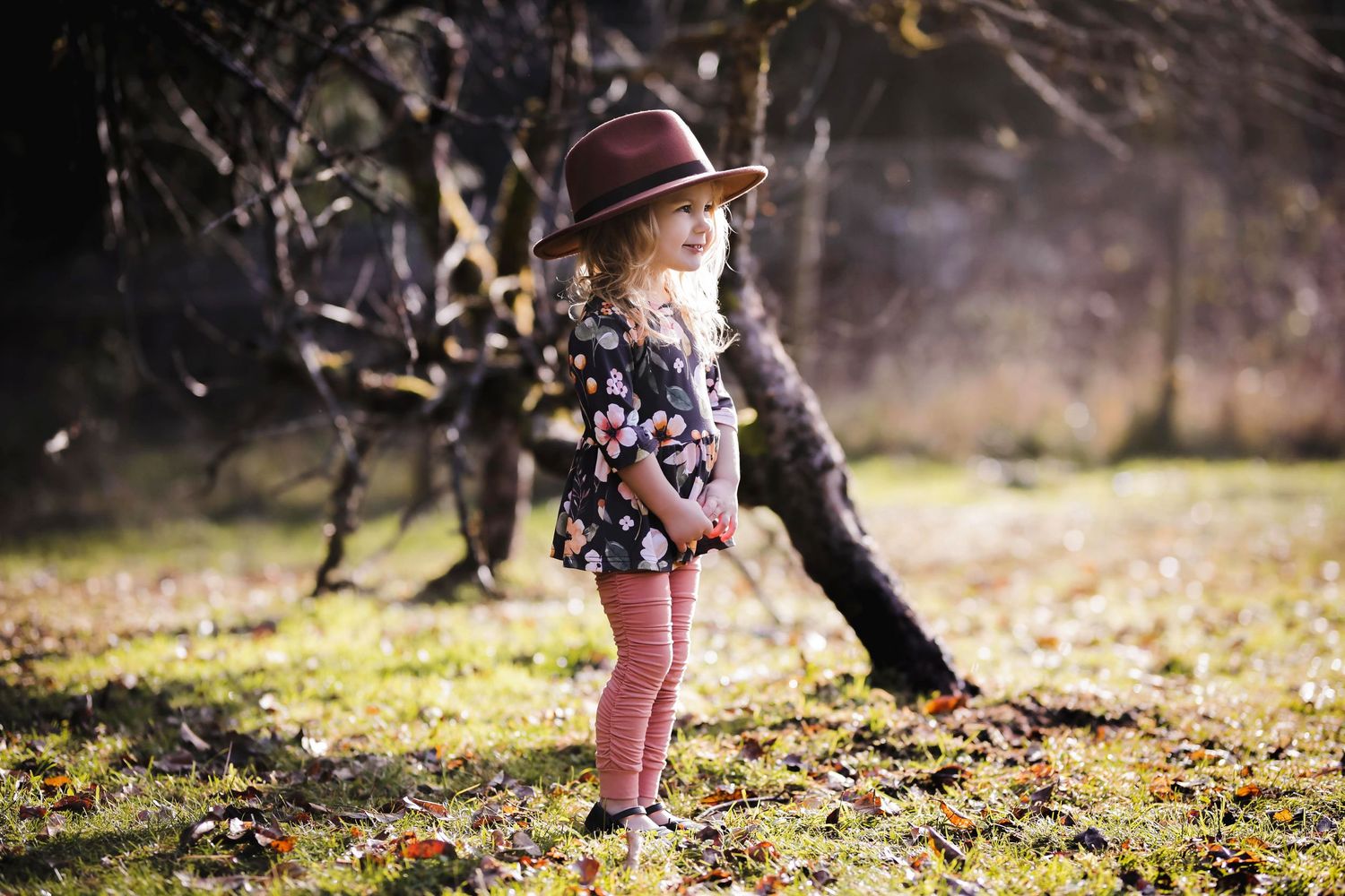 Girl standing near trees and grass in Qualicum Beach