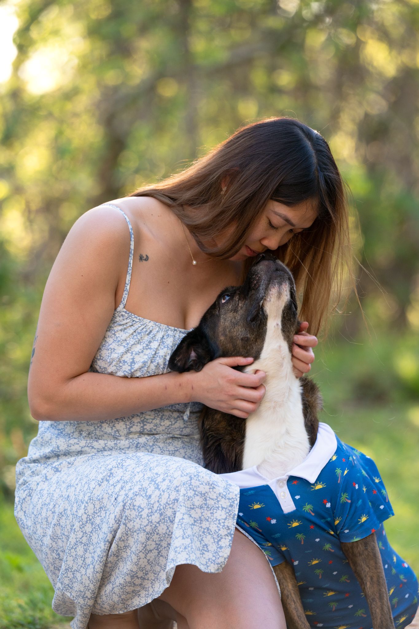Pet owner and dog sharing a quiet moment during a fear-free pet photography session in Houston"