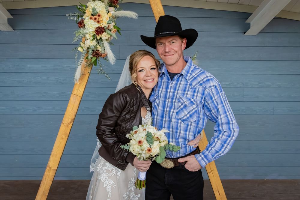 a bride hugging a man in a blue plaid shirt with a cowboy hat.Family lifestyle session in Alberta by Creation Photography