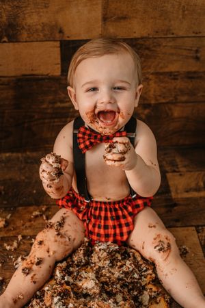toddler wearing plaid for lumberjack theme cake smash