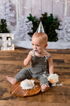 boy eating cake at winter wonderland cake smash