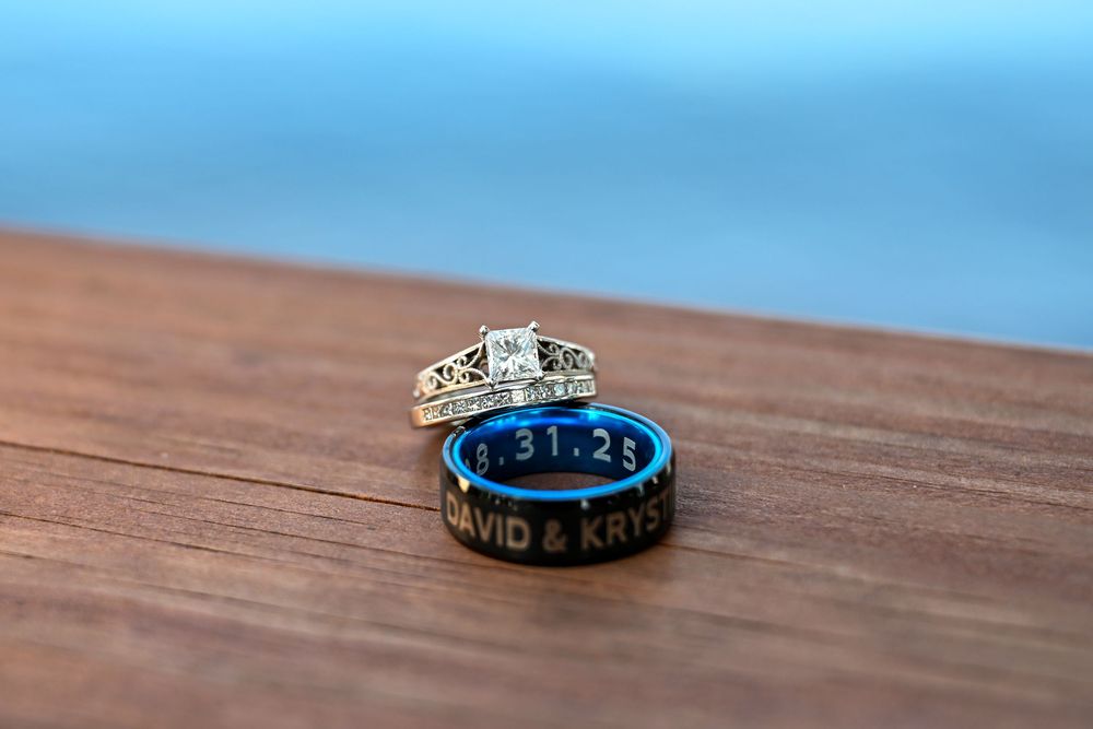 Diamond engagement ring and engraved black blue band reading