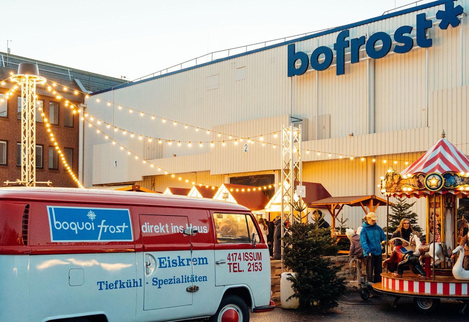 Bofrost branded food truck or van parked at an outdoor event with festive decorations. bofrost winter market corporate festival Straelen