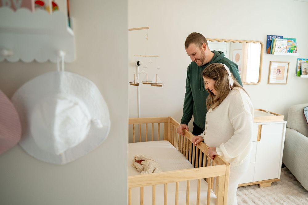 A montage of nursery decoration scenes showing paper lanterns and crib setup in a bright white room.