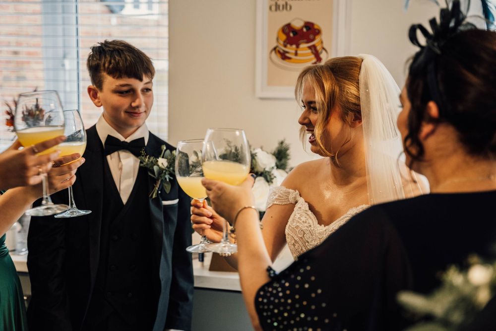 Wedding party members interact during pre-ceremony celebrations.