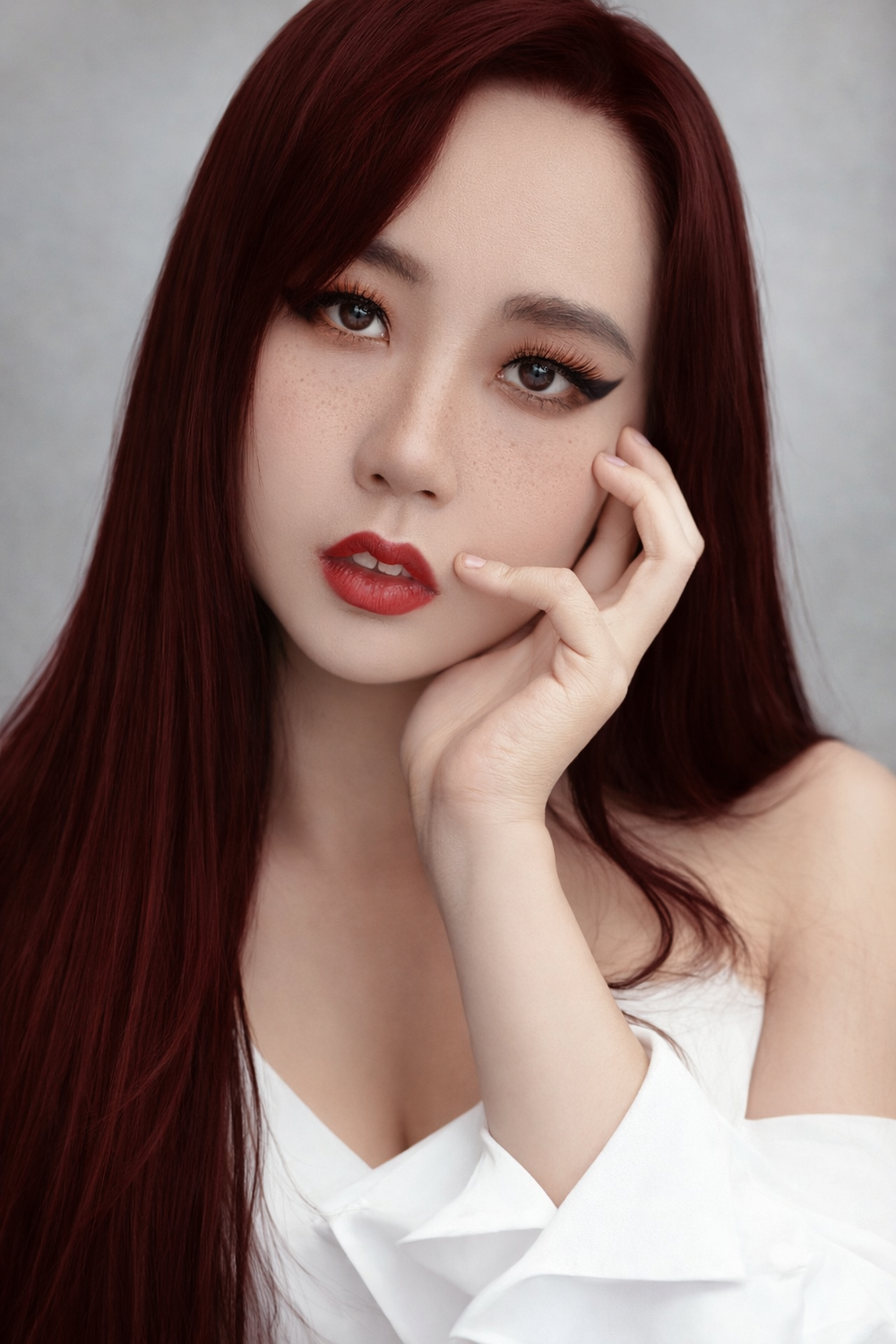A series of portrait photos showing someone with long dark hair wearing a white top and red lipstick in various poses.