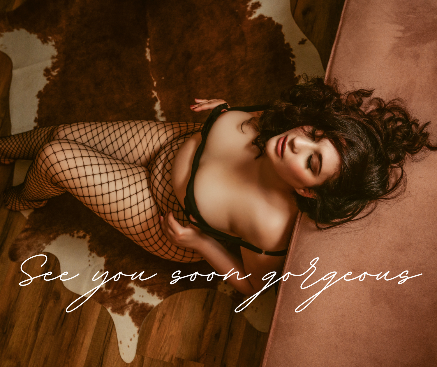 Artistic boudoir portrait with moody lighting and textured backdrop.