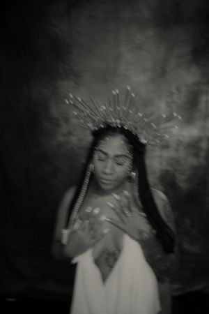 Dreamy black and white portrait with crown headpiece in mystical atmosphere.
