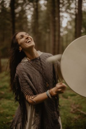Joy filled moment spinning with white balloon in forest setting.