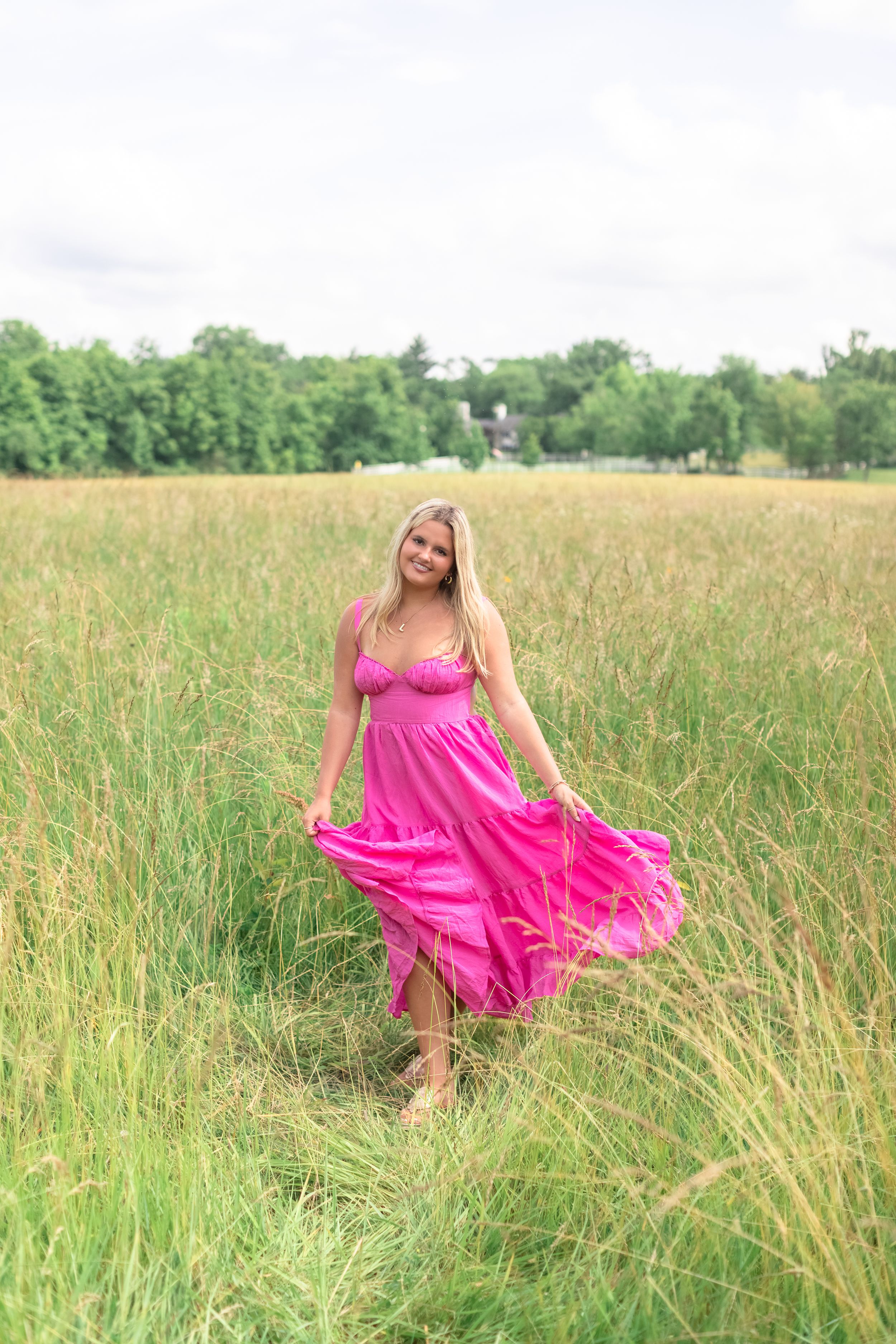 High school senior during her Spring 2026 Cincinnati senior portraits in a field. Authentic senior photography by Faith’s Flicks.