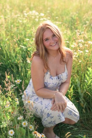 High school senior during her Spring 2026 Cincinnati senior portraits in a field. Authentic senior photography by Faith’s Flicks.