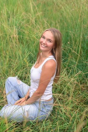High school senior during her Spring 2026 Cincinnati senior portraits in a field. Authentic senior photography by Faith’s Flicks.