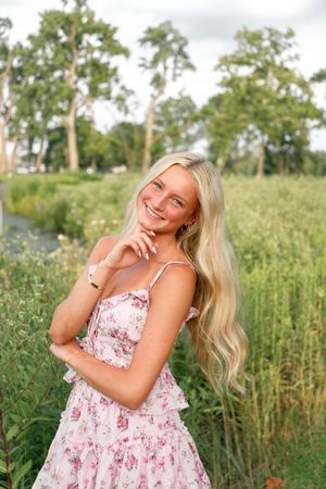 High school senior smiling during her St. Louis senior portraits at Forest Park. Authentic senior photography by Faith’s Flicks.