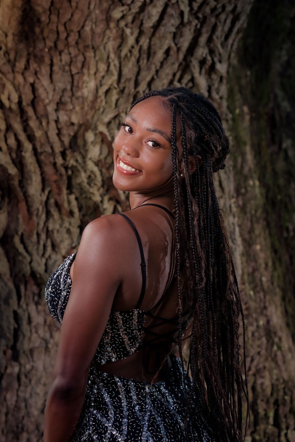 Portrait series showing a person with braids in a sparkly dress posing against a textured tree trunk background.