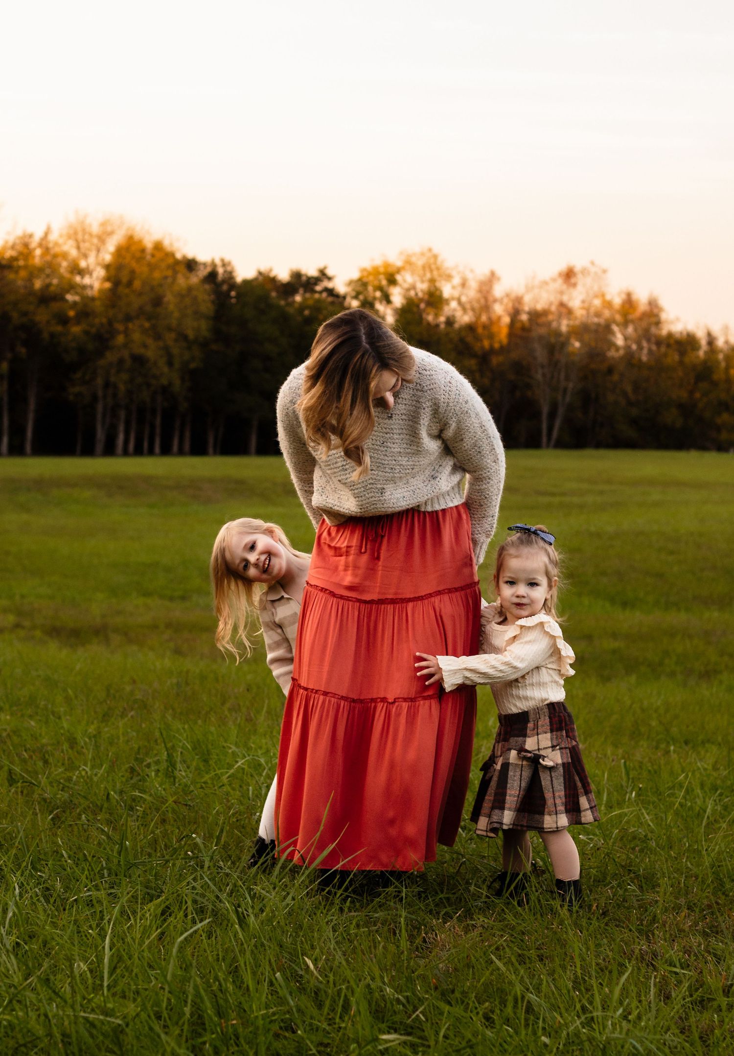 Harrisonburg photographer, newborn, family, baby, maternity, mom in orange skirt playing peek-a-boo with daughters