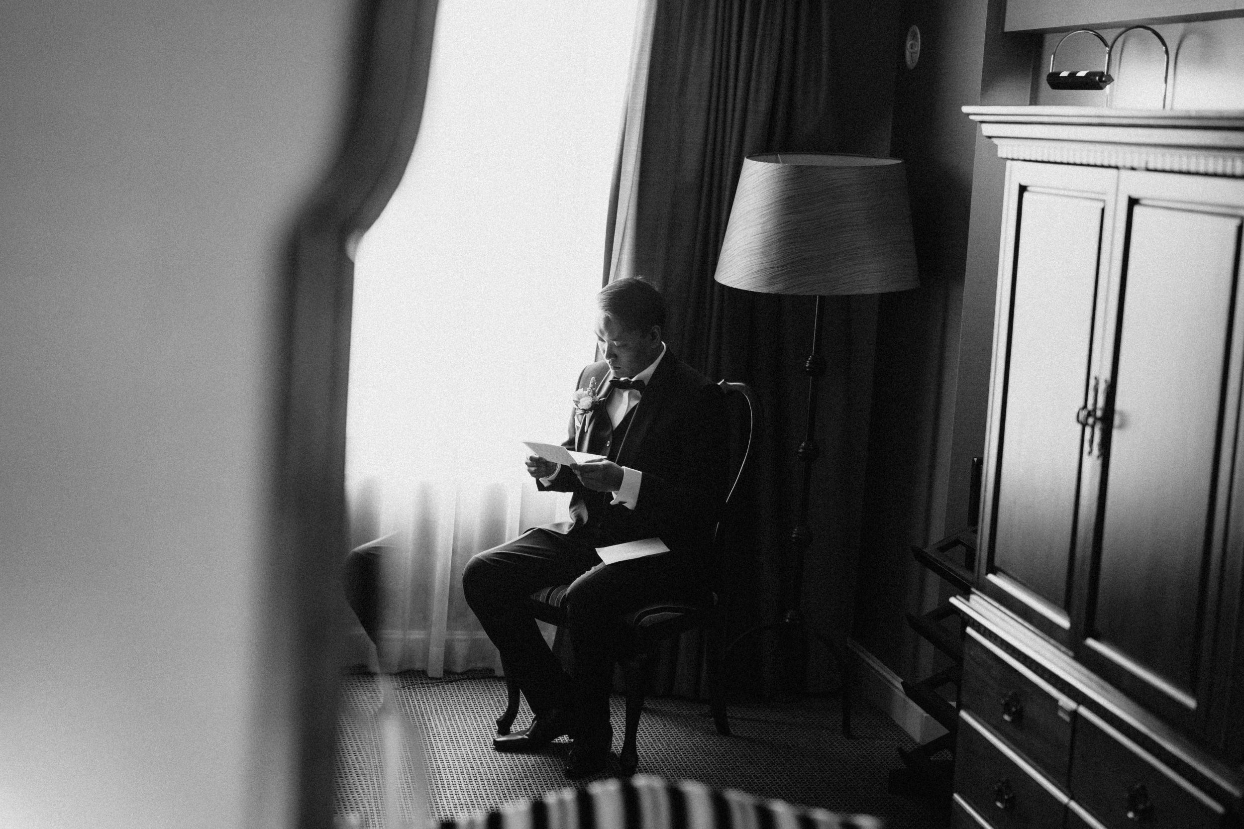 Groom’s emotional reading a letter by Brisbane wedding photographer"