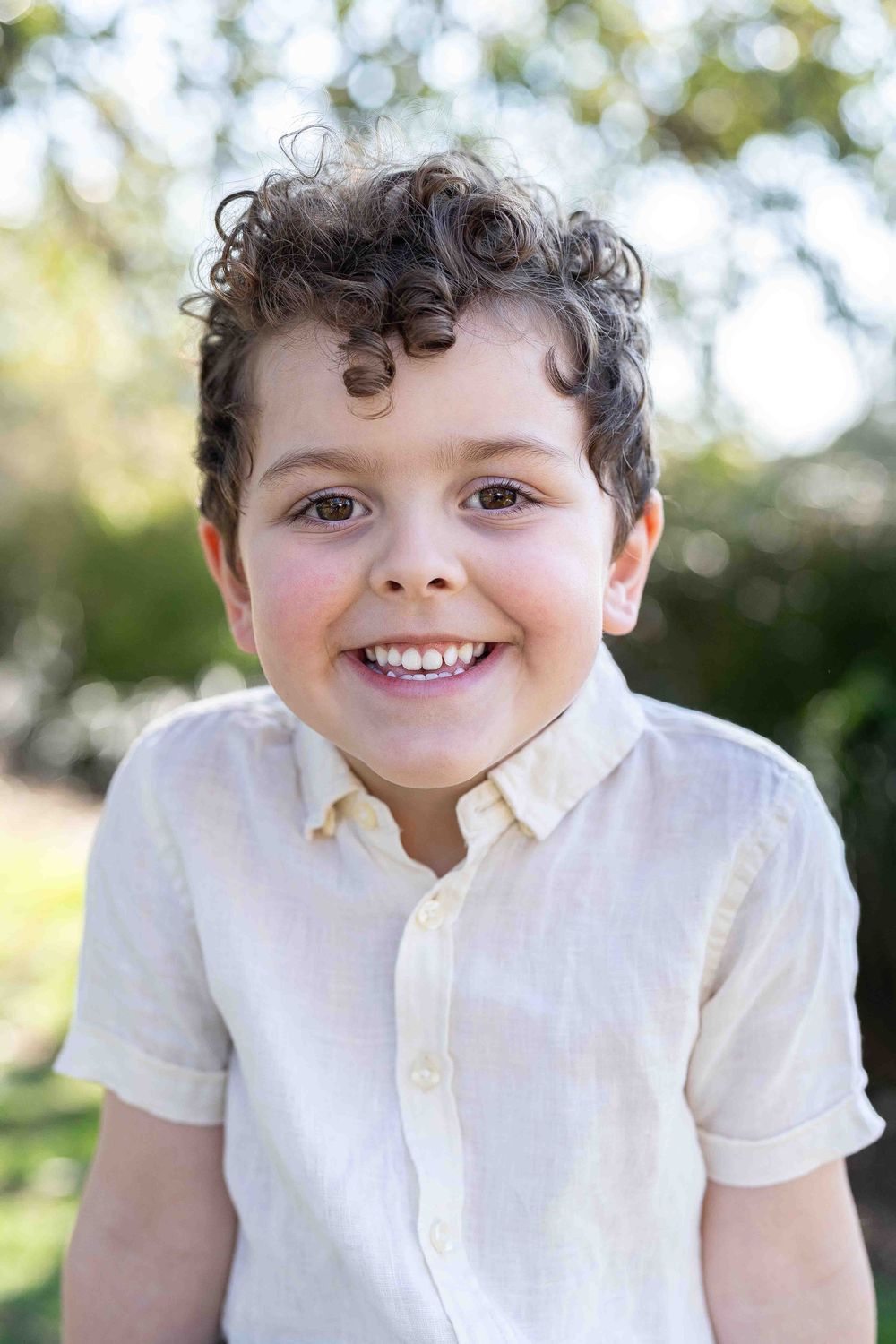 Artistic timeless portrait of a 3-year old boy in beautiful soft flattering light at an outdoor popup in Perth