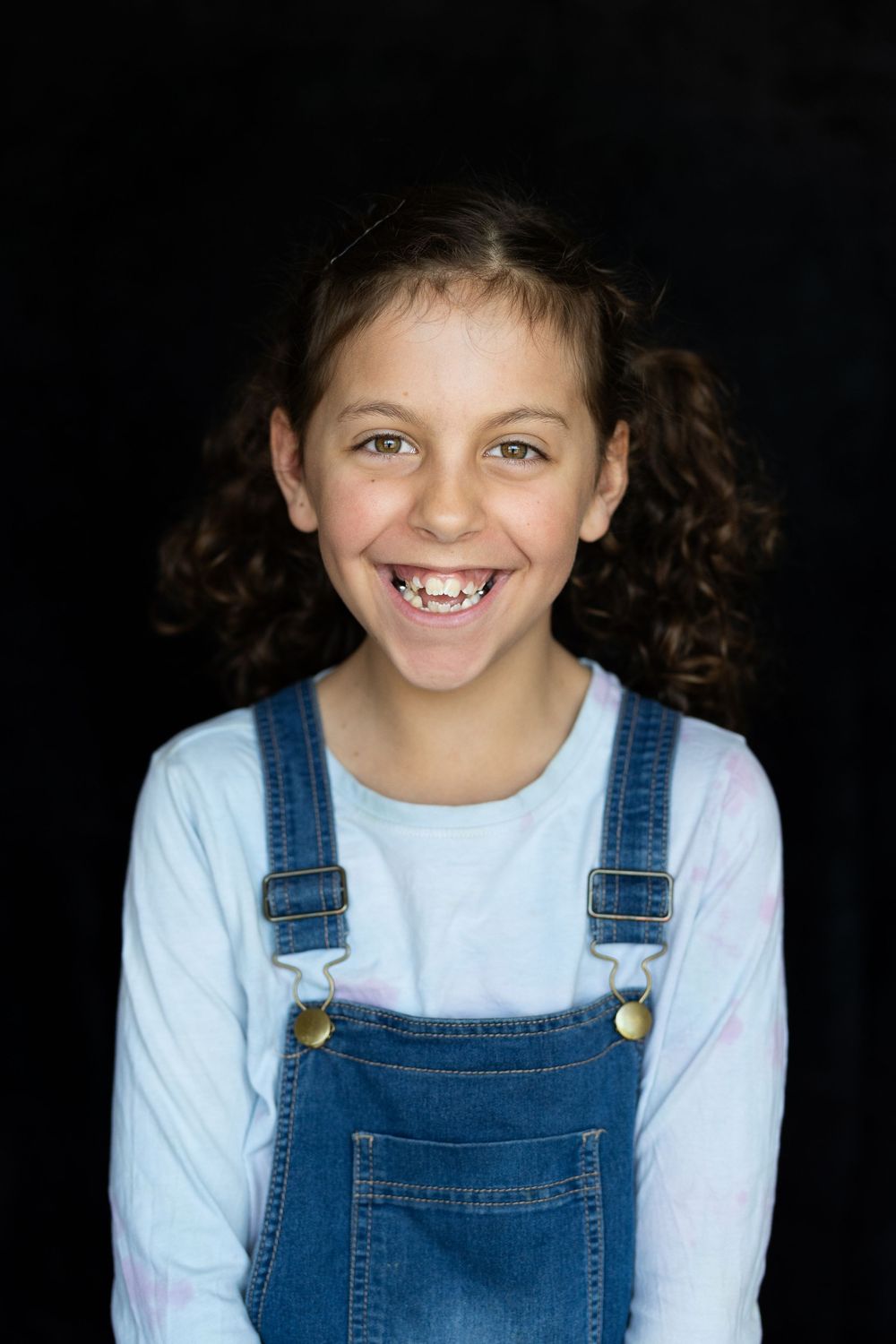 Fine art school portrait of a child against a black backdrop
