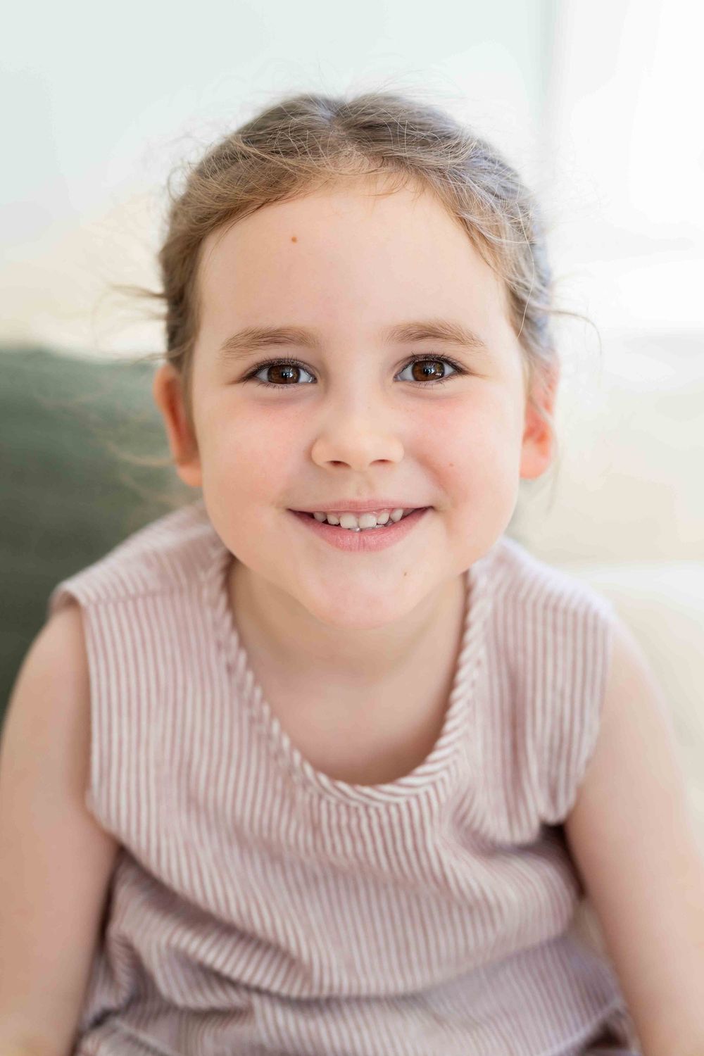 Portrait of a young girl in mid-morning light at an indoor family photography session in Perth
