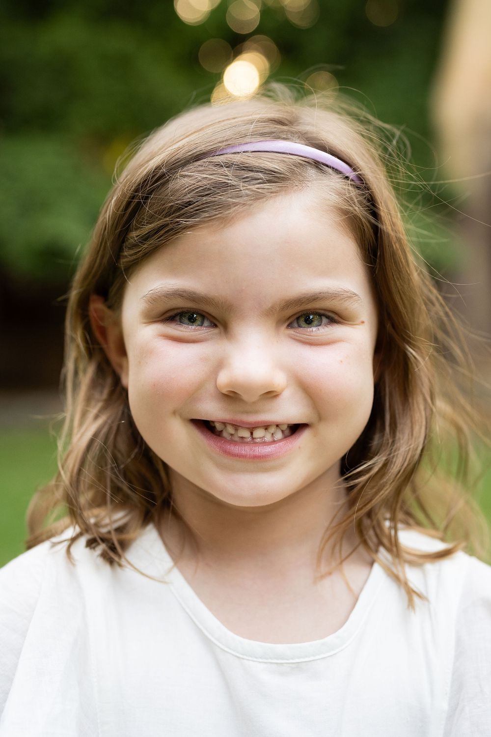 Portrait of a young girl in golden light at an outdoor sunset family photography session in Perth