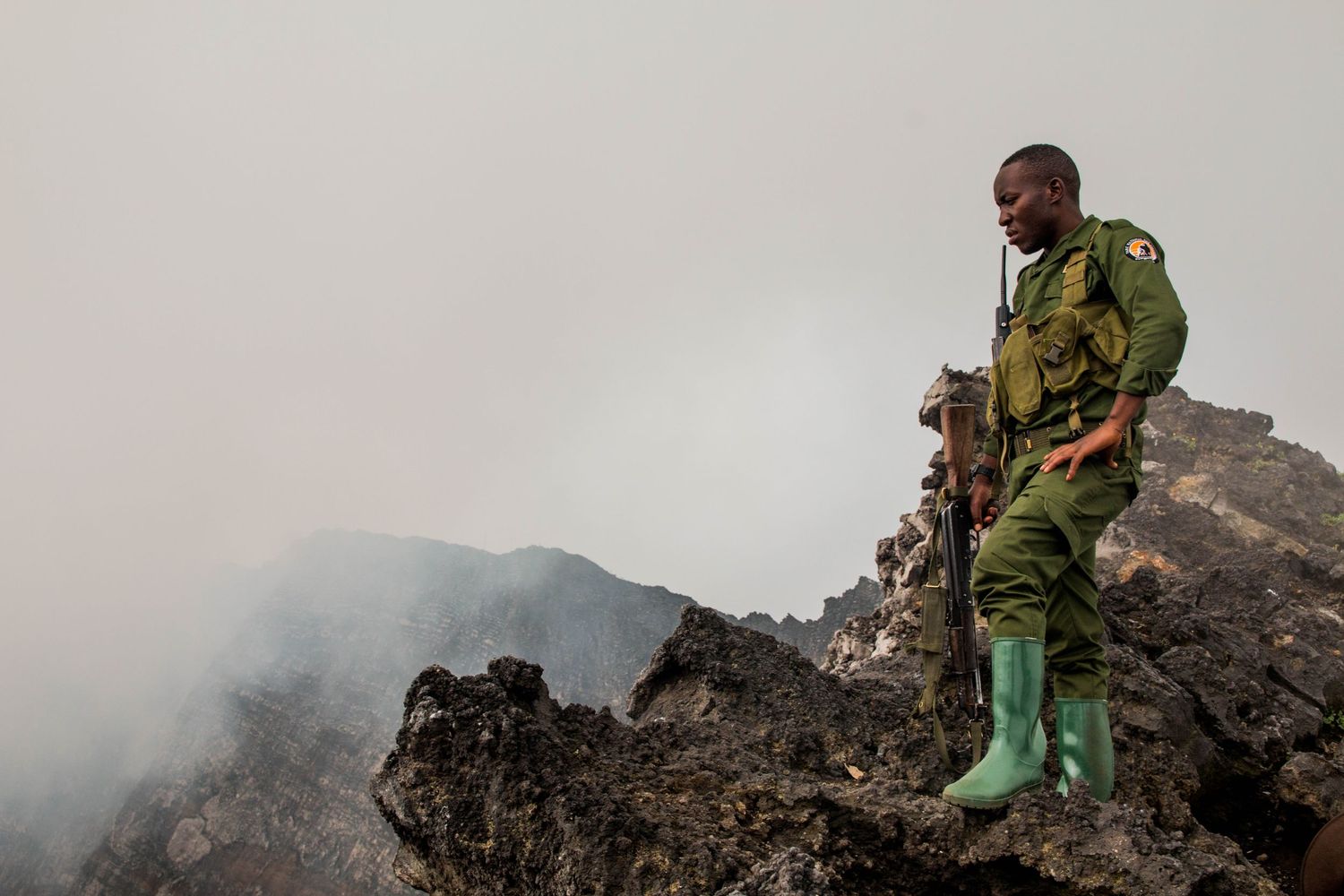 Military personnel traversing rocky mountain terrain in combat gear. Virunga, congo, ranger