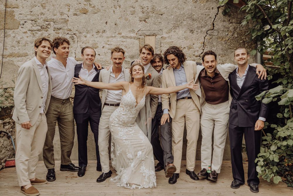 A wedding party poses playfully together in a fun group photo showing their personalities and style.