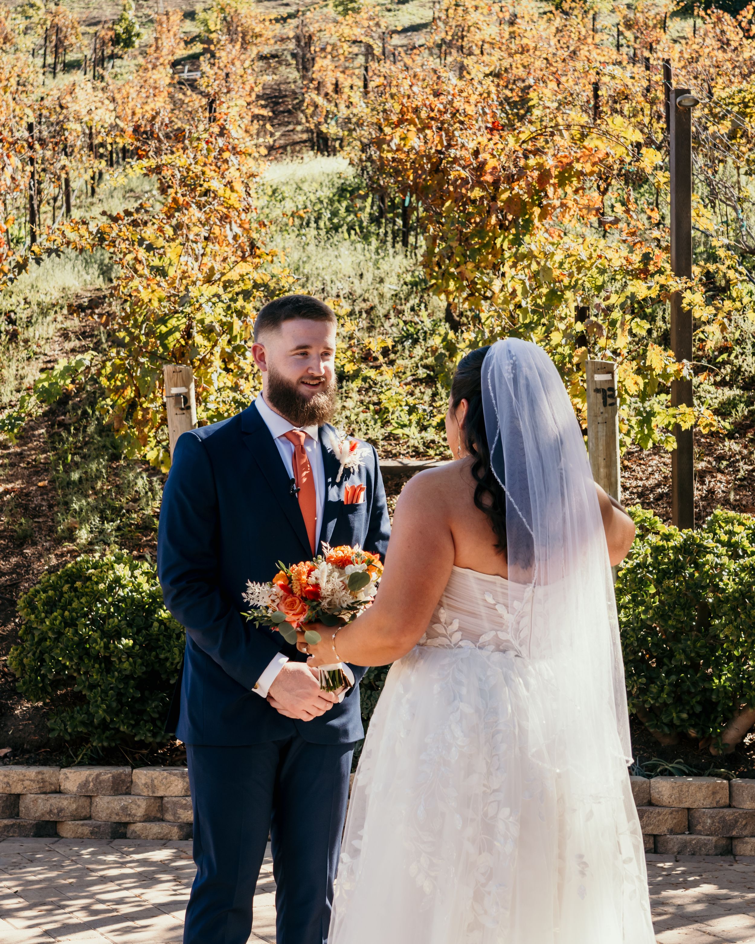 A wedding ceremony sequence showing a couple exchanging vows in an outdoor autumn setting with fall foliage.