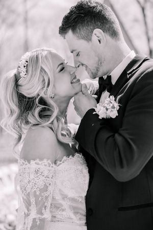 A romantic black and white wedding portrait capturing a tender moment.