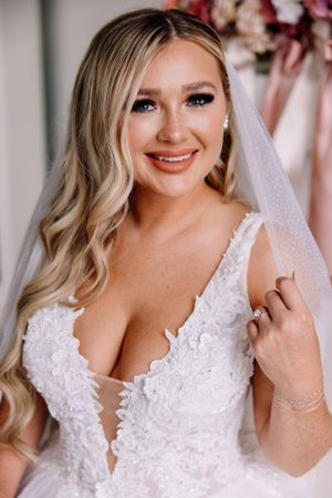Close-up bridal portraits showcasing a detailed lace wedding dress and soft makeup.