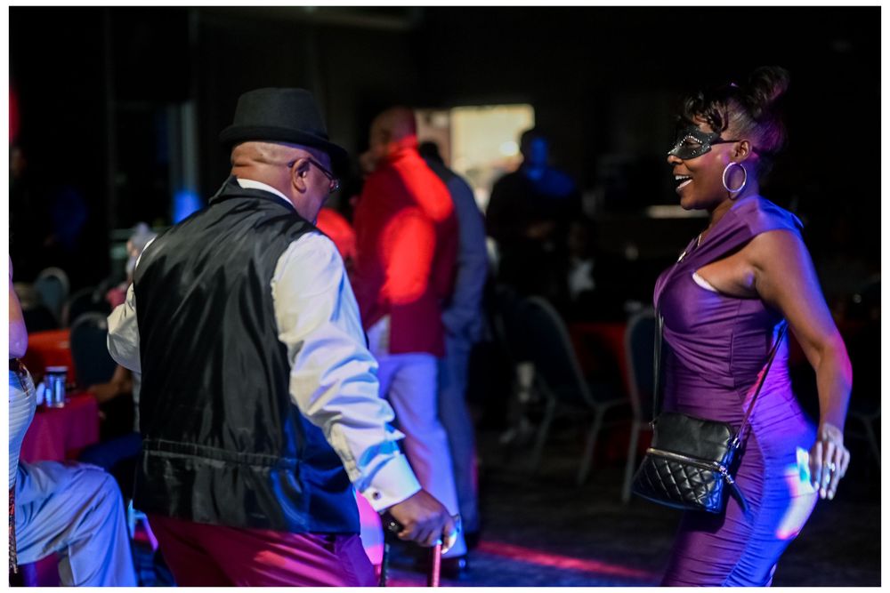 Dance party scene with colorful blue and red lighting effects.