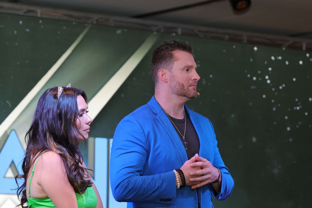 Speakers present on stage at a professional conference or event.