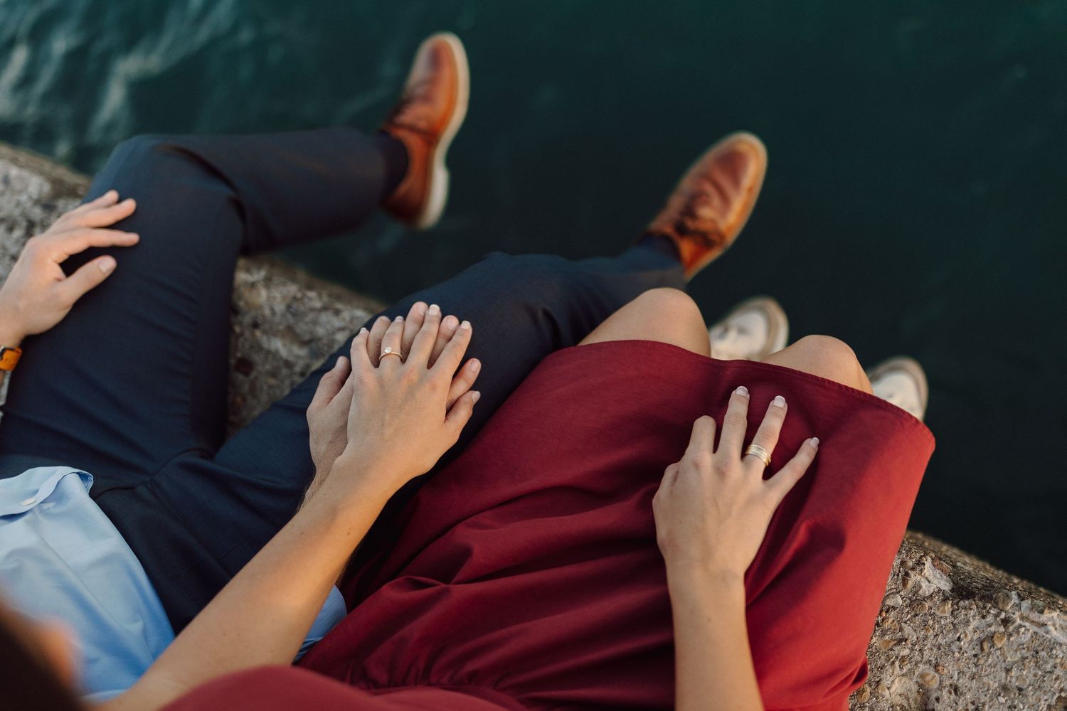 Close-up detail of couple sitting together by Lake Michigan with city backdrop.