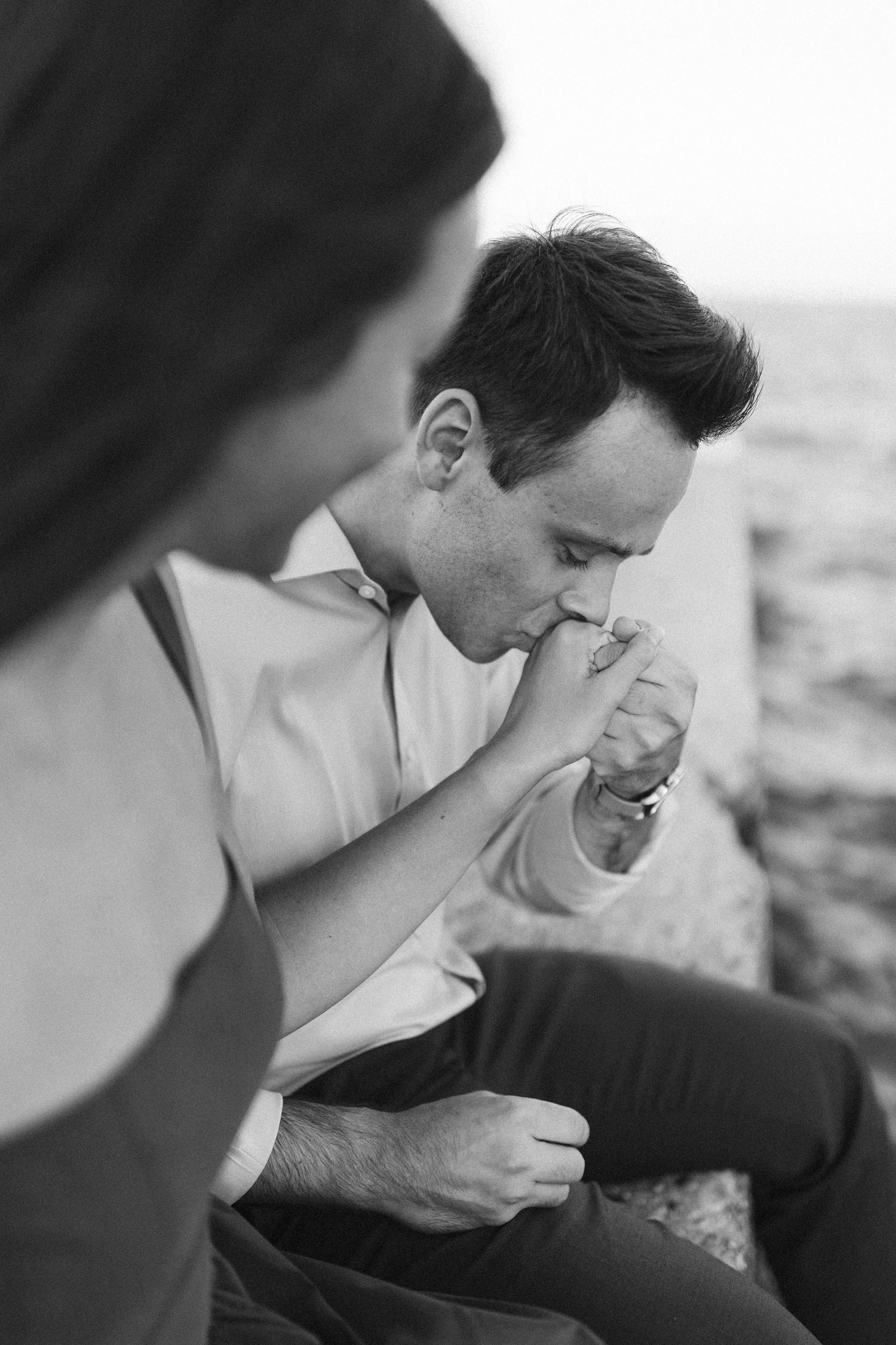 A couple sharing an intimate close-up moment together against a blurred background.