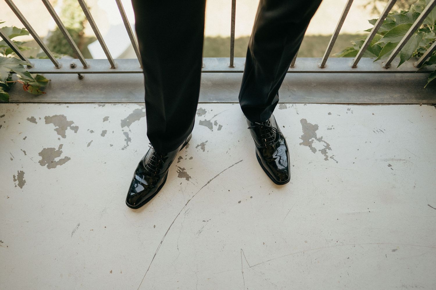 Feet in black shoes stand on a white surface with a sequence of multiple steps showing movement.