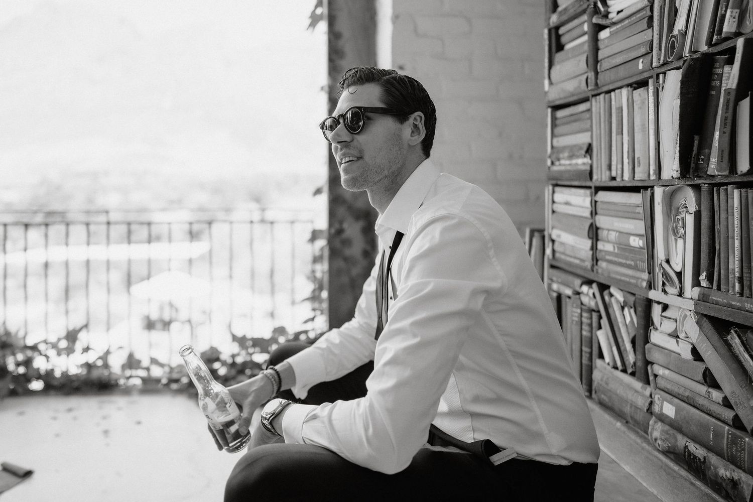 A series of black and white photographs showing someone working at a desk in an office setting.