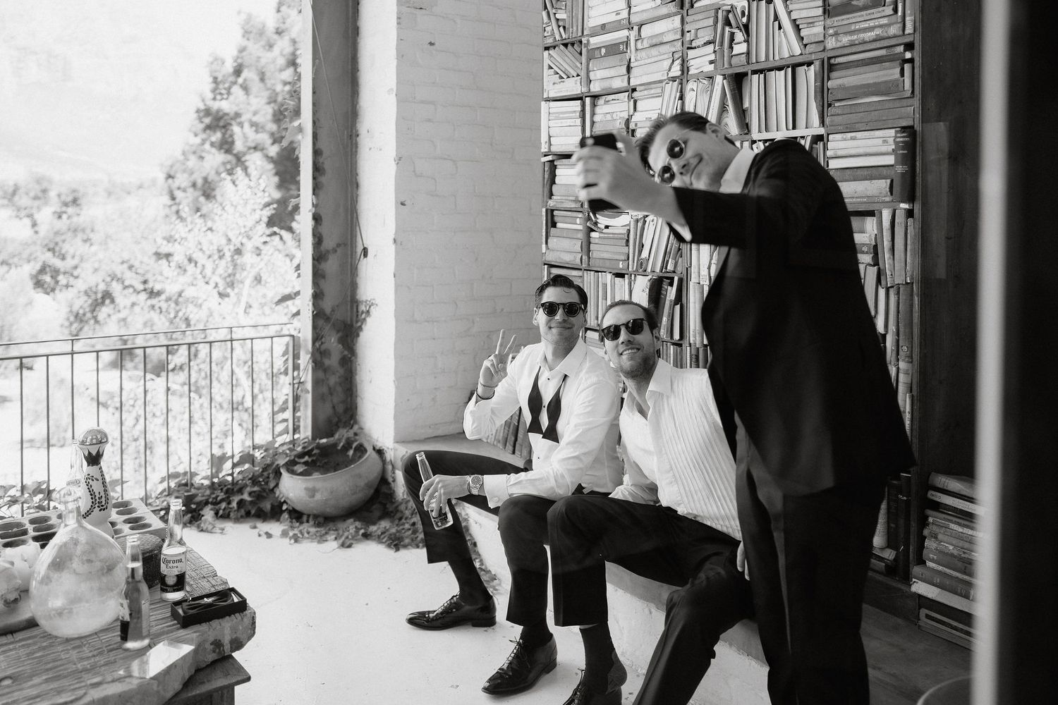 A black and white photo collage showing intimate wedding moments on a porch with elegant decor and natural lighting.