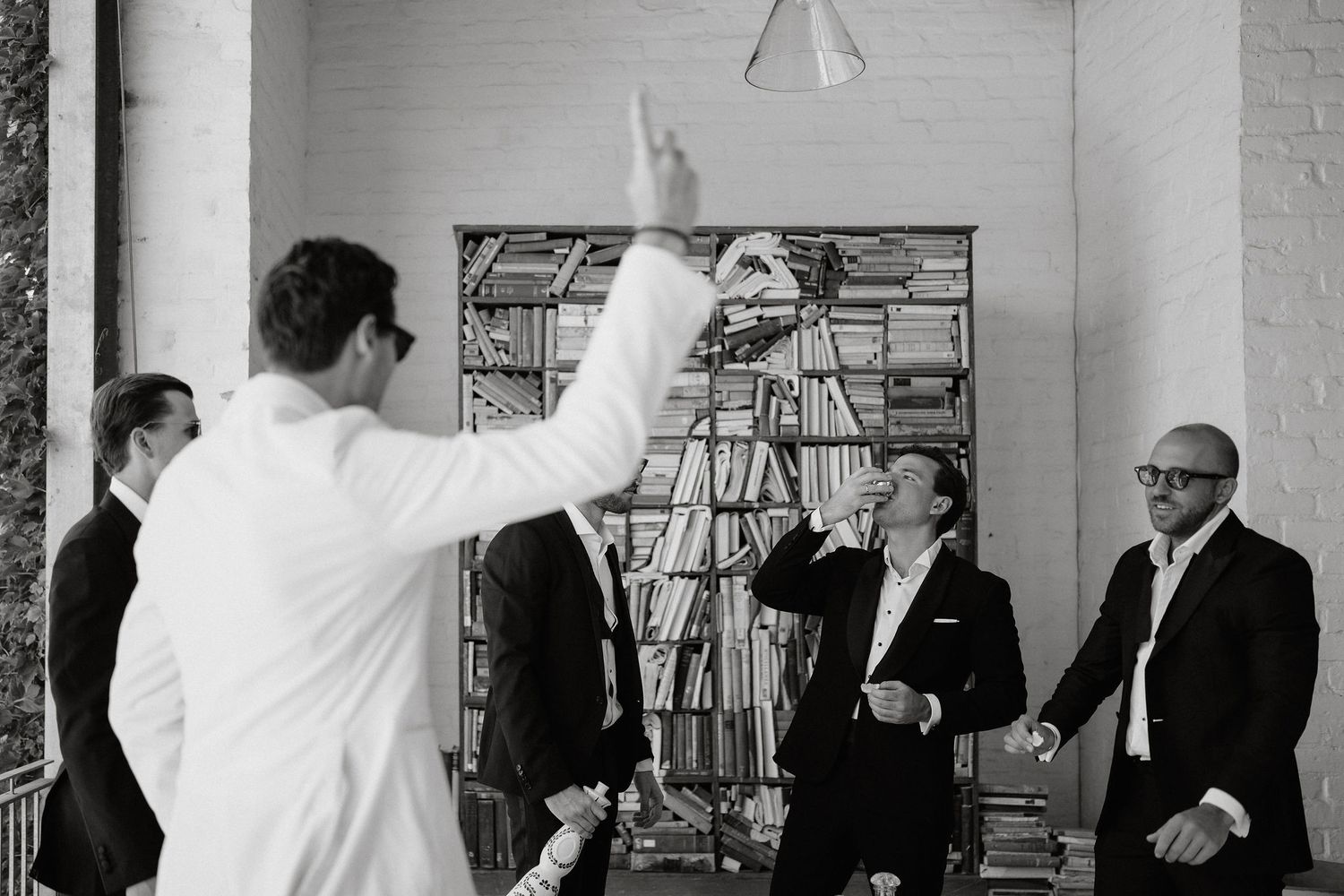 A series of black and white photographs showing people with raised hands in various formal settings.