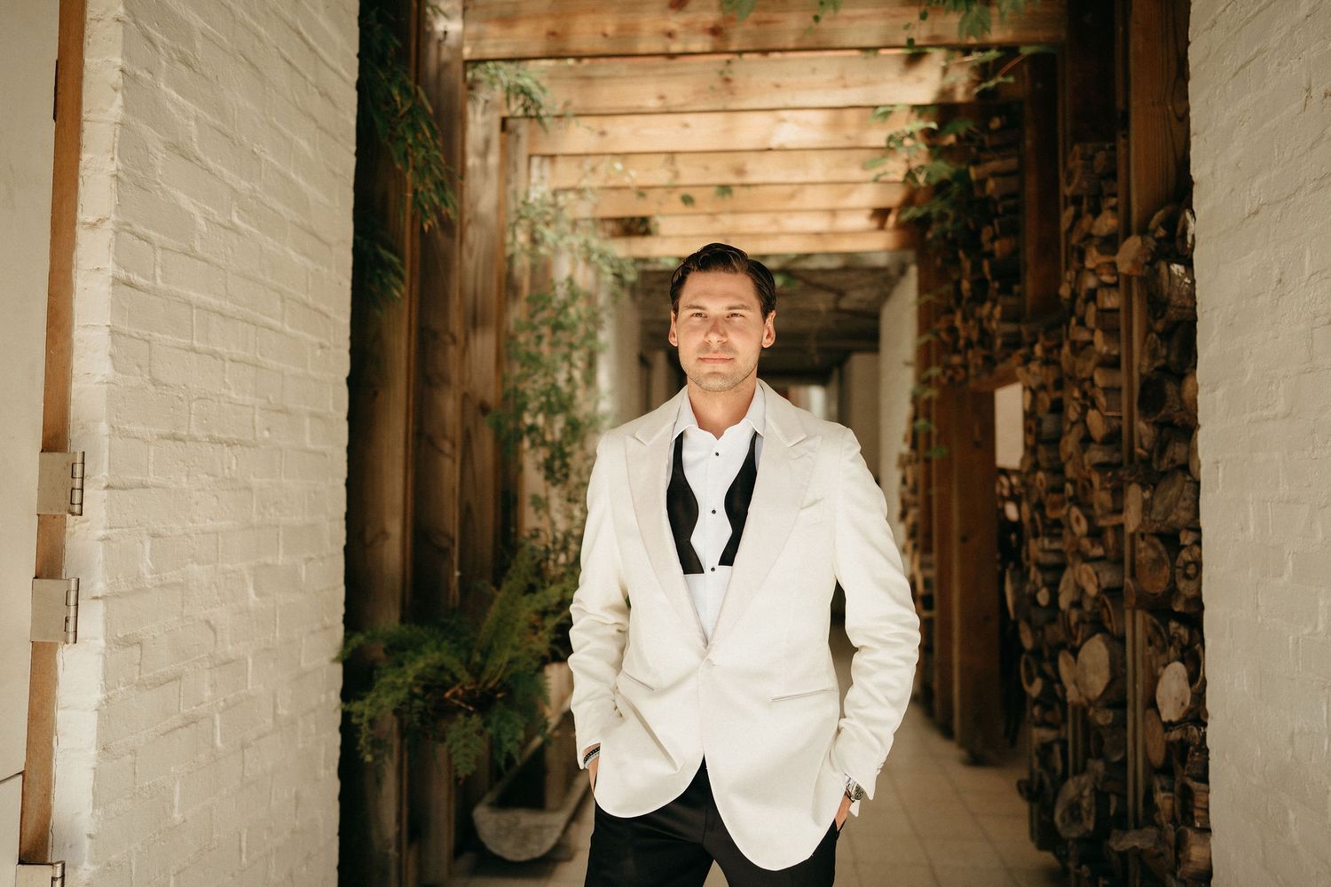 A series of five similar photos showing someone in a white suit jacket standing against a white wall.