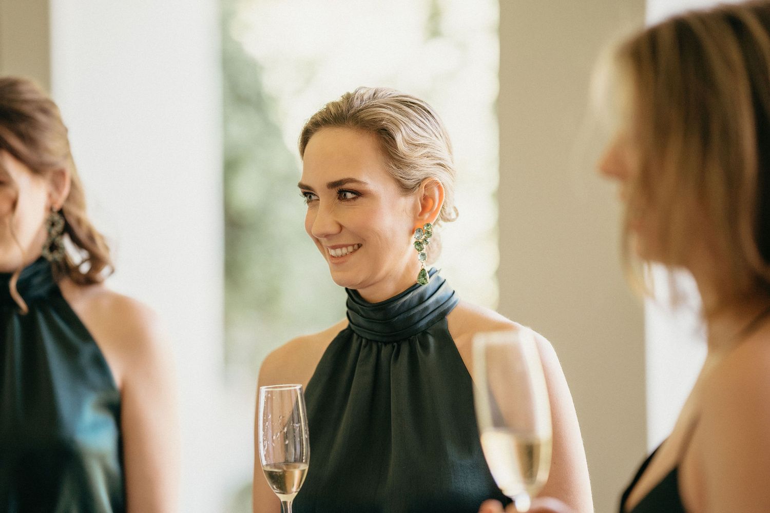 A series of candid moments captured during a social gathering with guests in formal attire enjoying conversation and wine.
