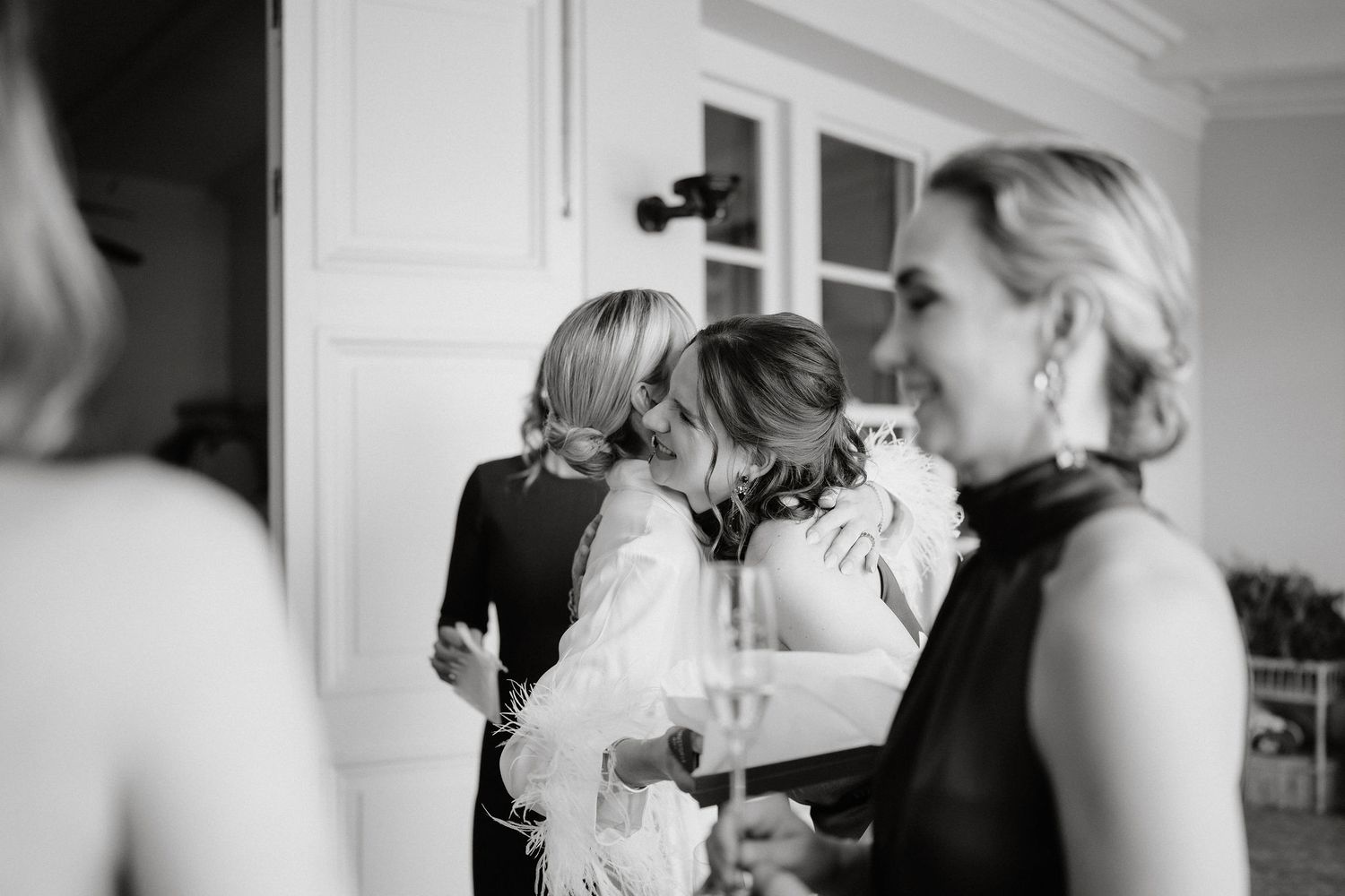 A series of black and white wedding photos showing intimate moments between people during a celebration.