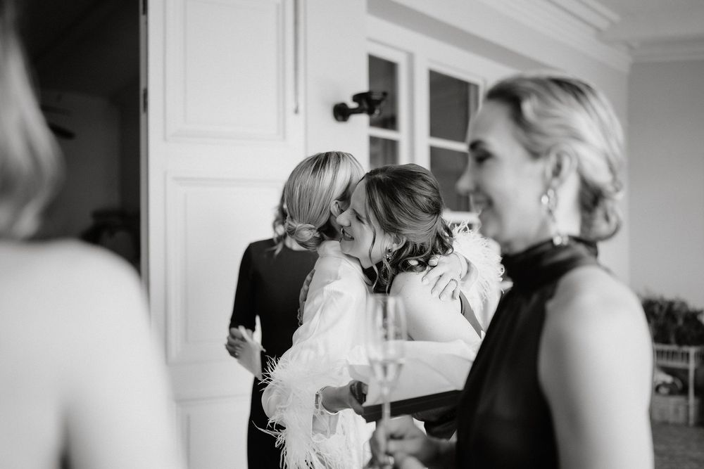 A series of black and white wedding photos showing intimate moments between people during a celebration.