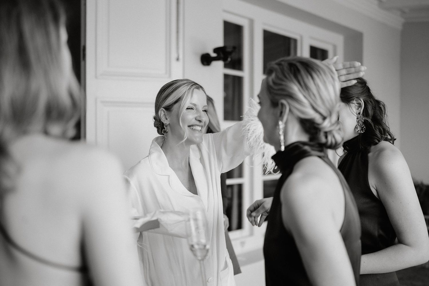 A series of black and white wedding preparation photos showing dress details and intimate getting ready moments.